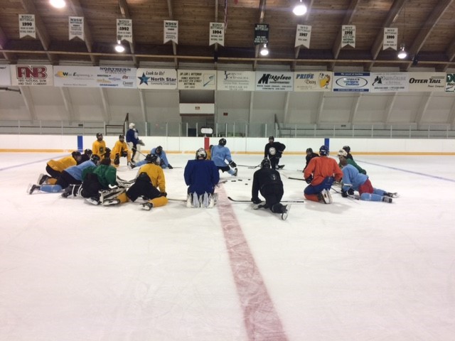 Lumberjacks stretch in preparation for tonight's Green and White game.