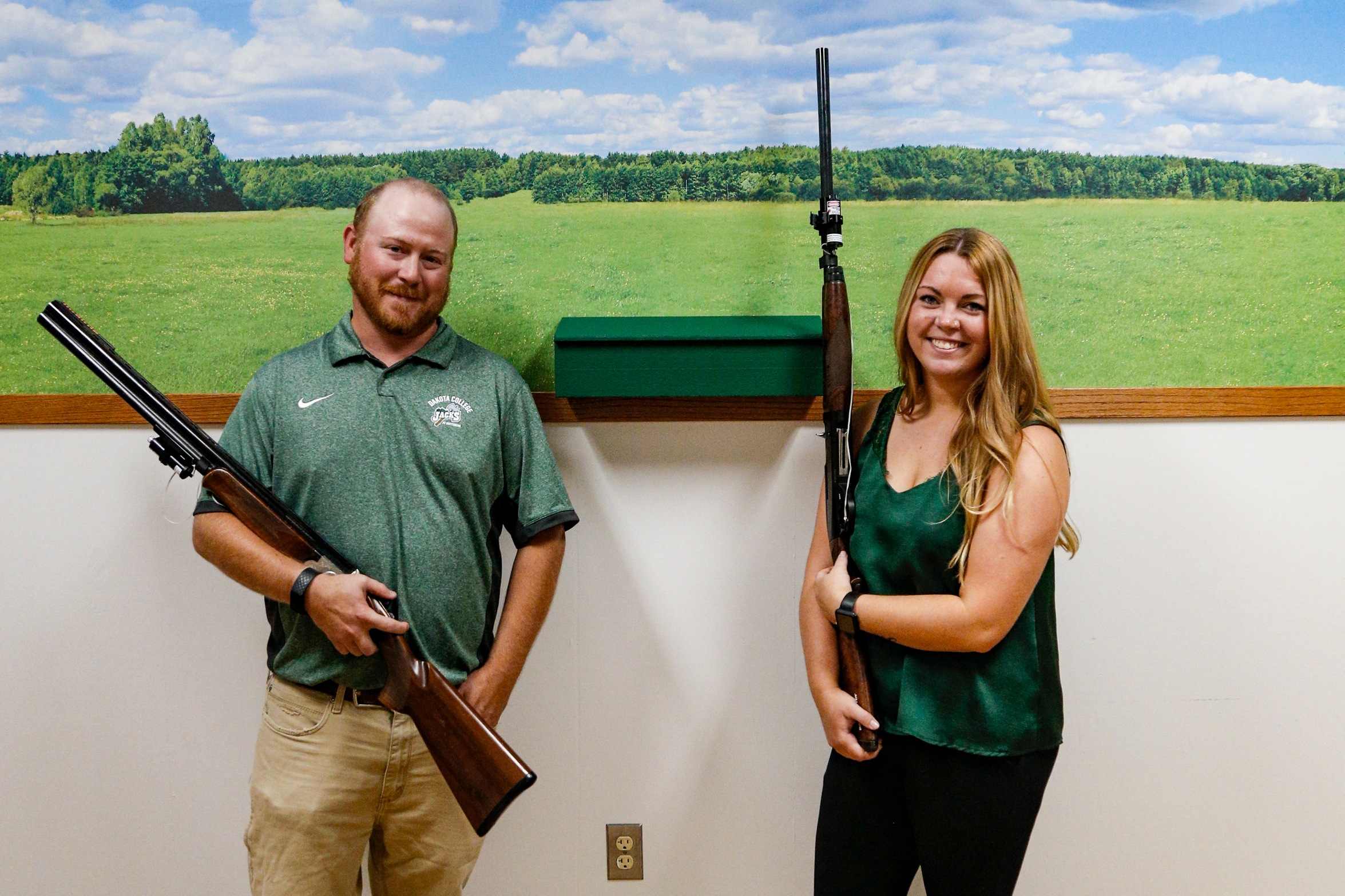 A photo of the coaches holding their guns
